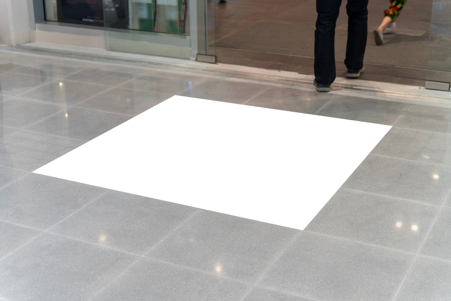 Mockup blank screen on floor at front of automatic door at shopping mall